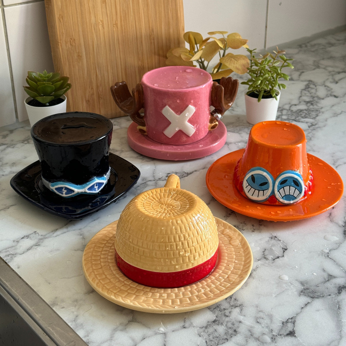 Strawhat mugs on a kitchen counter: Luffy, Ace, Sabo and Chopper with their saucers