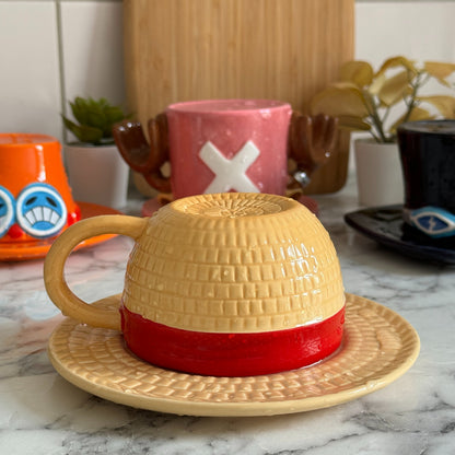Luffy straw hat mug, cup flipped onto its saucer to form the hat