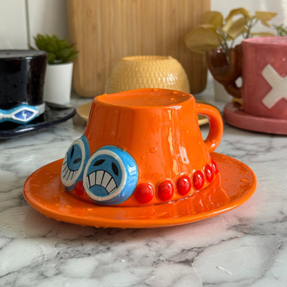 Ace orange hat mug, cup flipped onto its saucer