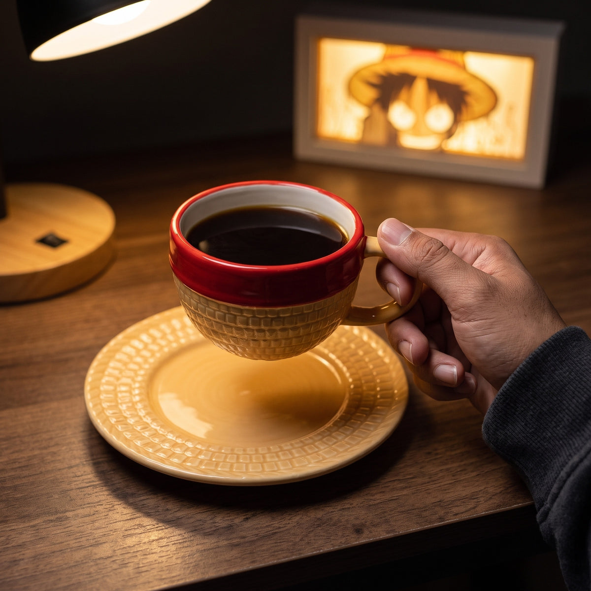 Luffy straw hat mug filled with coffee, held by the handle